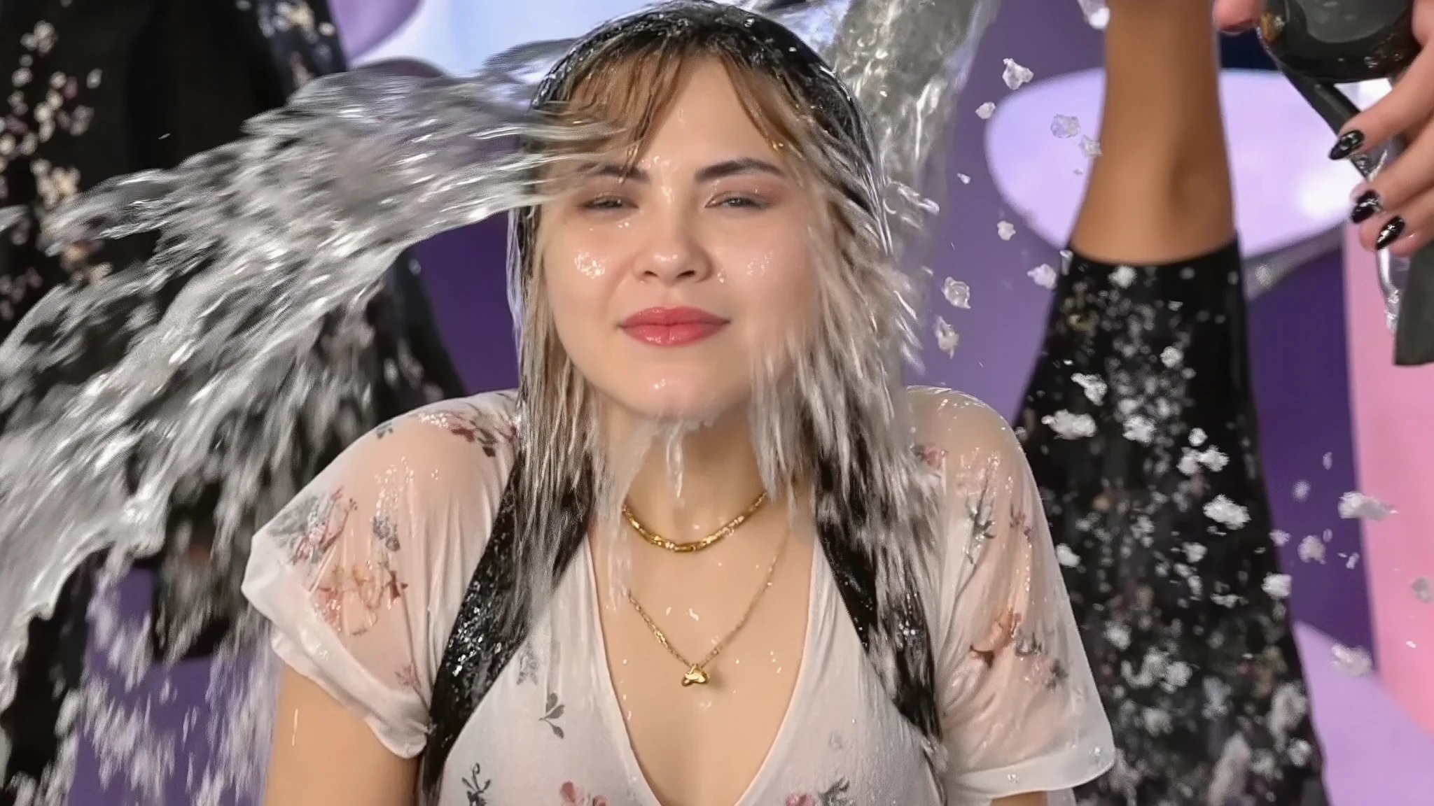 Beautiful young 18-year-old model with long pale blonde hair, cream floral dress with puff sleeves, drenched in cascading water, crystalline rivulets streaming down face, false eyelashes and sparkly eyeshadow visible through water streams, glossy lipstick, thin gold necklace, long black press-on nails, thin gold jewellery glinting through water drops, outdoor lighting, carnival setting, photorealistic portrait, close-up, dramatic water splash captured in motion, high-speed photography. High saturation.