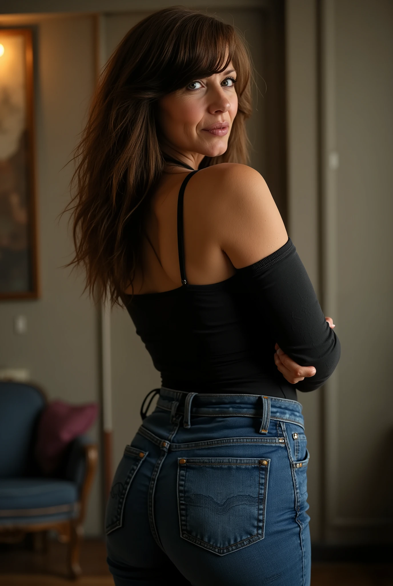 rear view portrait in basement setting, full body shot from behind of a slim, dominant strict stepmom in her 50s with European Caucasian features, candid photorealistic style in 8k resolution, visual focus on her shapely but realistic buttocks in form-fitting dark blue straight-leg jeans, completely straight caramel brown hair with precise face-framing bangs and visible roots, head turned showing partial profile with one piercing ice-light blue eye projecting authority and discipline, stern expression with slightly furrowed brow, fine crow's feet and expression lines from years of enforcing household rules, thin pursed lips with natural fine vertical lip lines, basement ambient lighting creating sharp shadows as she stands with arms crossed, wearing a fitted black cold-shoulder top with thin straps revealing toned shoulders, upper back skin with realistic texture showing slight natural looseness and subtle age spots, commanding stance with straight posture suggesting she's caught someone breaking rules, slim figure maintained through strict self-discipline, basement environment suggesting she's interrupted her organization to address misbehavior, ultra-realistic skin details including natural pores, fine lines and the weathered look of someone who maintains high standards