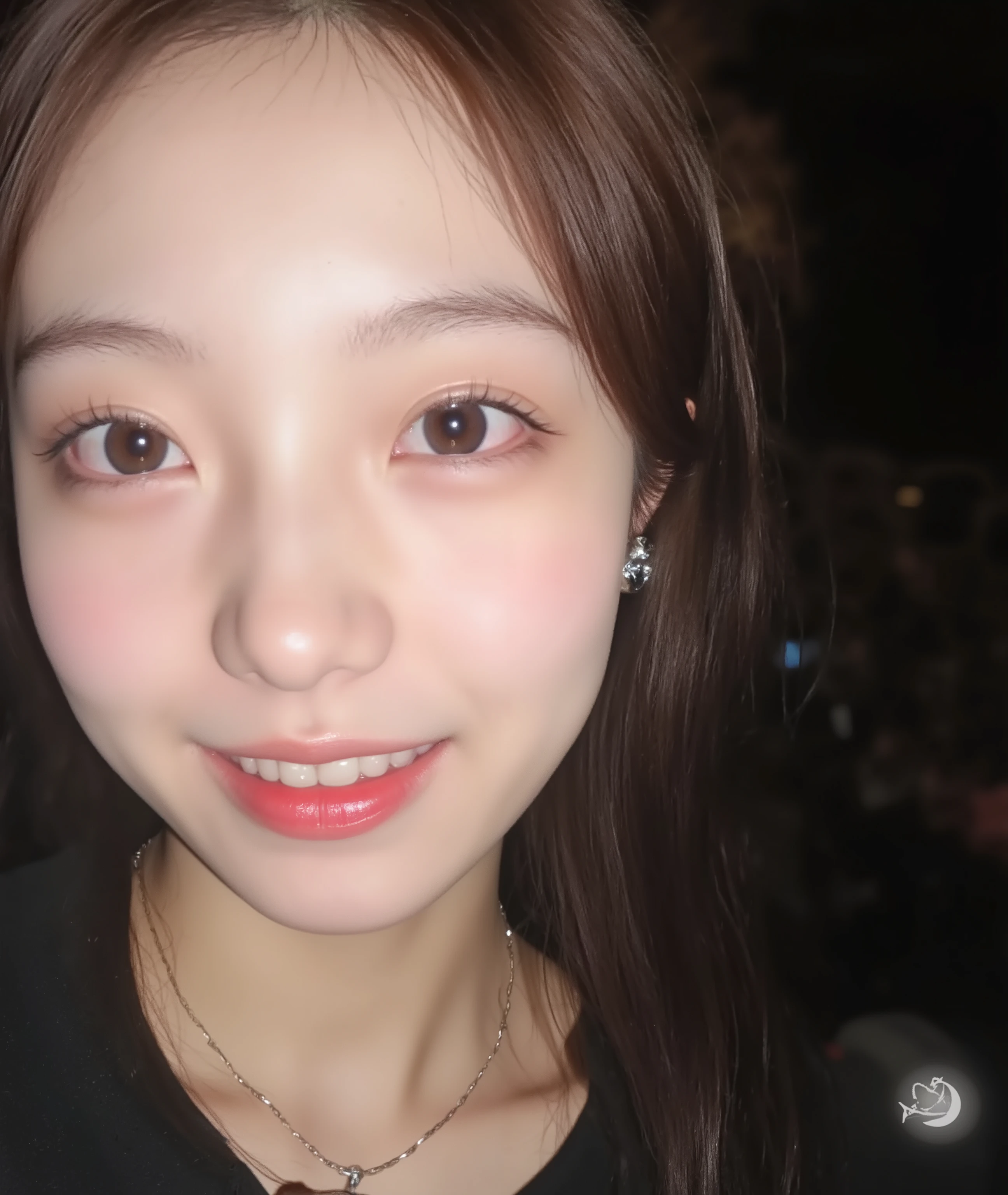 The image is a close-up photograph of a young Asian woman with a fair complexion. Her face dominates the frame, occupying the majority of the image, with her eyes, nose, and lips prominently visible. She has large, almond-shaped eyes with long, thick eyelashes, and her skin is smooth and soft. Her lips are full and slightly parted, revealing a natural, rosy hue. She wears a small silver stud earring in her left ear, adding a subtle touch of personal style.

Her hair is long, dark brown with subtle highlights, and it partially covers her forehead, giving a slightly tousled, casual look. The background is out of focus, but it appears to be a dark, possibly indoor setting, which emphasizes her face and provides a stark contrast to her light complexion. She is wearing a black garment, possibly a top or a sleeve, which is visible at the bottom of the image. The overall mood of the photograph is intimate and personal, capturing a candid moment with a natural, unfiltered aesthetic.