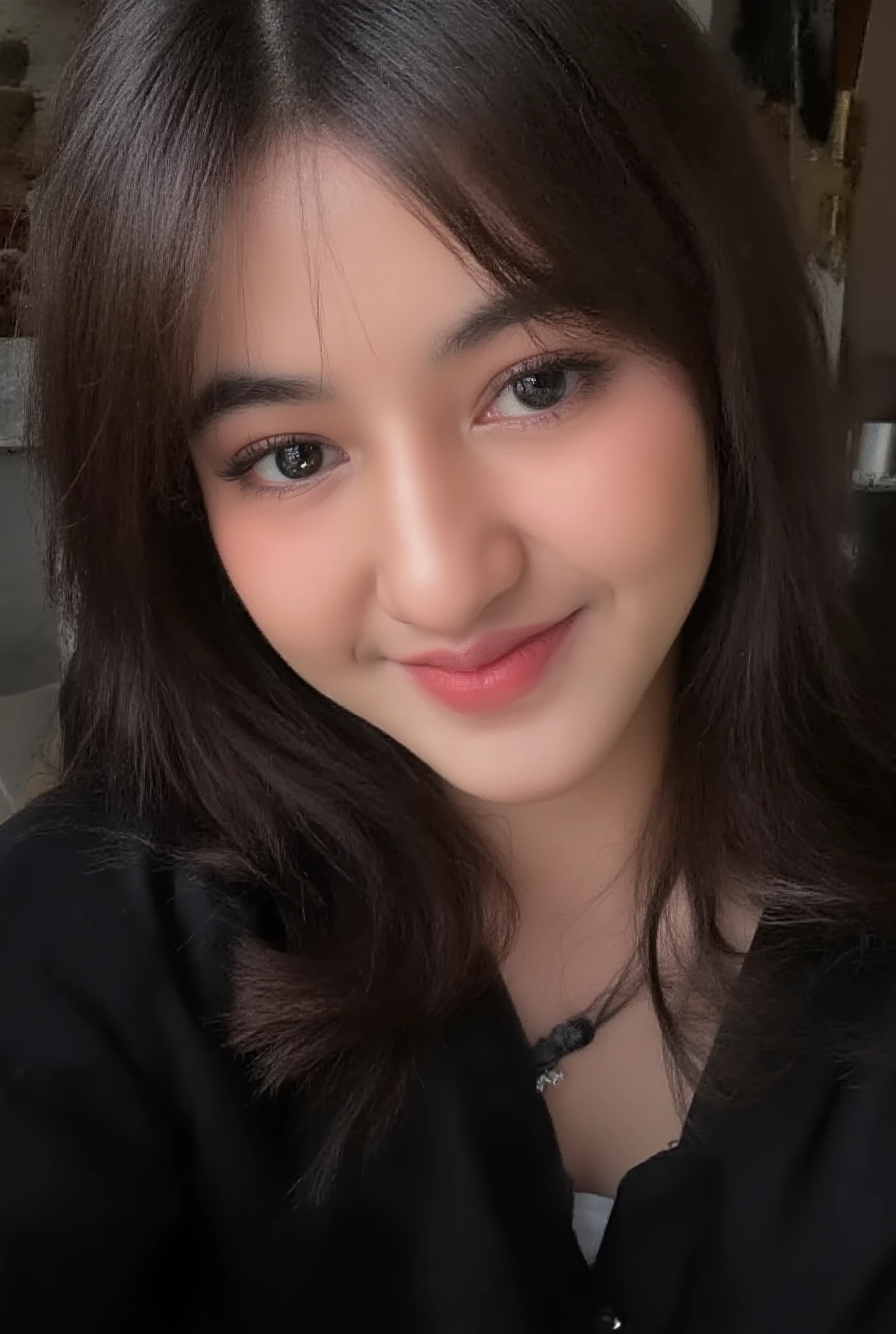 Close up photo of VonnyFelicia's face, very detailed. She is looking at the viewer with bright and loving eyes. She is leaning forwardal. She is wearing a perfect black soft shirt deep v-neck. Hasselblad H6D-400c MS, low exposure, high contrast, ISO 100, with a 120mm macro lens.