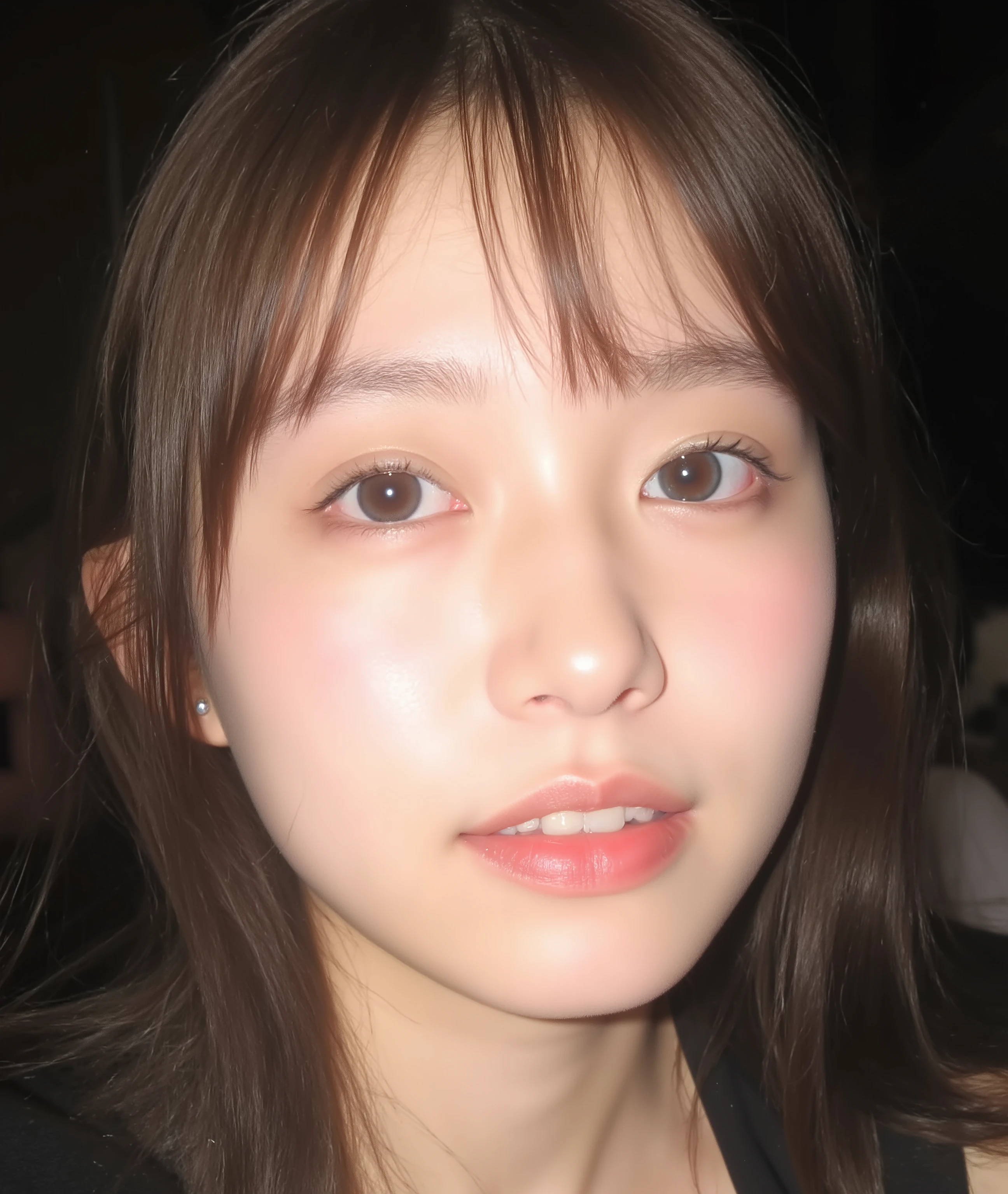 The image is a close-up photograph of a young Asian woman with a fair complexion. Her face dominates the frame, occupying the majority of the image, with her eyes, nose, and lips prominently visible. She has large, almond-shaped eyes with long, thick eyelashes, and her skin is smooth and soft. Her lips are full and slightly parted, revealing a natural, rosy hue. She wears a small silver stud earring in her left ear, adding a subtle touch of personal style.
Her hair is long, dark brown with subtle highlights, and it partially covers her forehead, giving a slightly tousled, casual look. The background is out of focus, but it appears to be a dark, possibly indoor setting, which emphasizes her face and provides a stark contrast to her light complexion. She is wearing a black garment, possibly a top or a sleeve, which is visible at the bottom of the image. The overall mood of the photograph is intimate and personal, capturing a candid moment with a natural, unfiltered aesthetic.