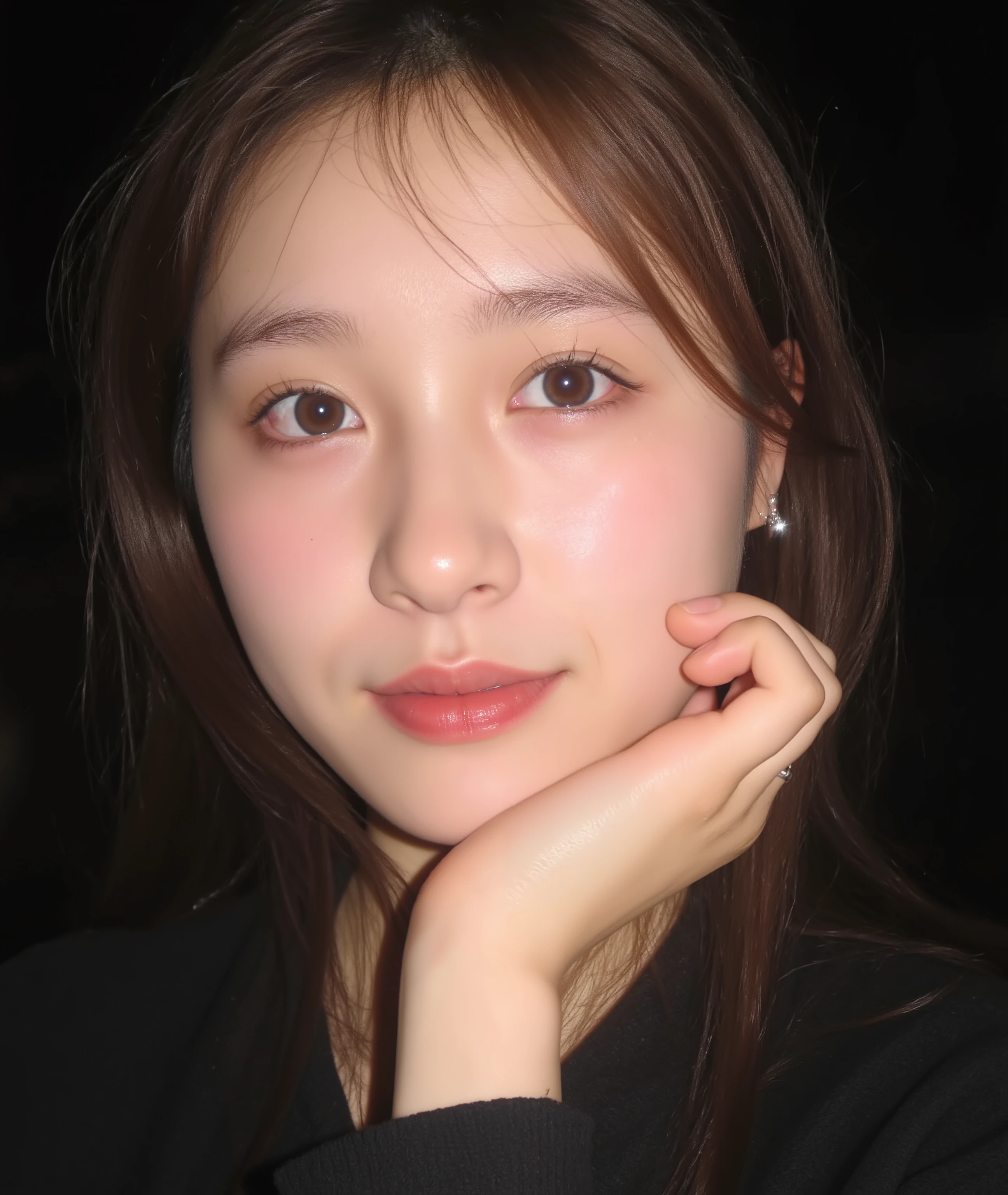 The image is a close-up photograph of a young Asian woman with a fair complexion. Her face dominates the frame, occupying the majority of the image, with her eyes, nose, and lips prominently visible. She has large, almond-shaped eyes with long, thick eyelashes, and her skin is smooth and soft. Her lips are full and slightly parted, revealing a natural, rosy hue. She wears a small silver stud earring in her left ear, adding a subtle touch of personal style.

Her hair is long, dark brown with subtle highlights, and it partially covers her forehead, giving a slightly tousled, casual look. The background is out of focus, but it appears to be a dark, possibly indoor setting, which emphasizes her face and provides a stark contrast to her light complexion. She is wearing a black garment, possibly a top or a sleeve, which is visible at the bottom of the image. The overall mood of the photograph is intimate and personal, capturing a candid moment with a natural, unfiltered aesthetic.