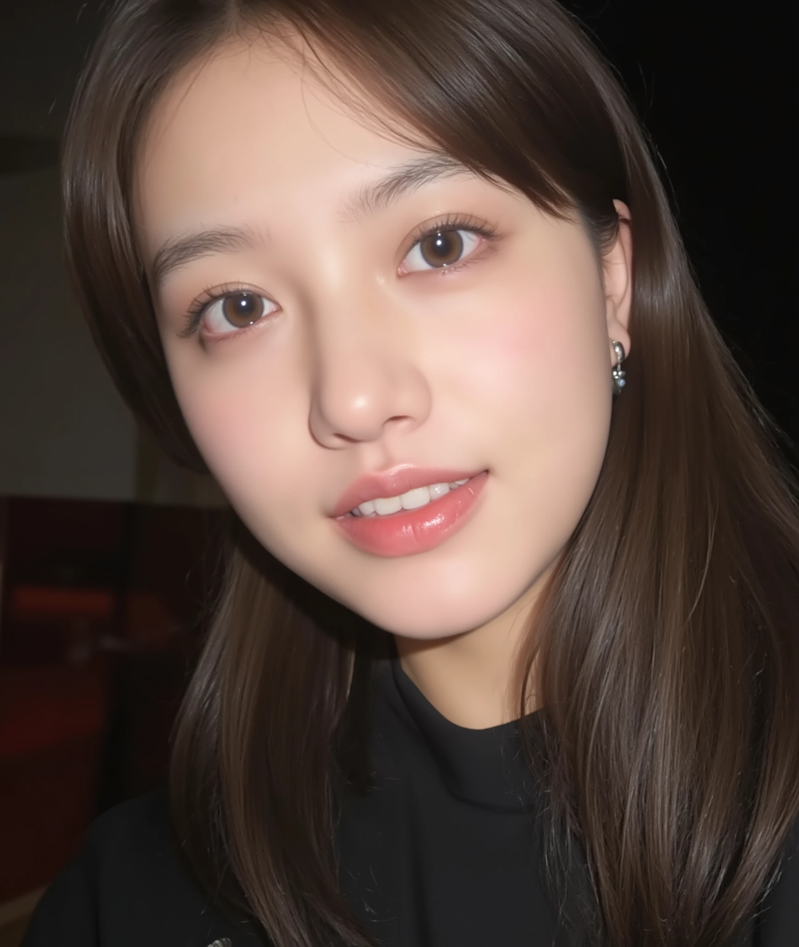 The image is a close-up photograph of a young Asian woman with a fair complexion. Her face dominates the frame, occupying the majority of the image, with her eyes, nose, and lips prominently visible. She has large, almond-shaped eyes with long, thick eyelashes, and her skin is smooth and soft. Her lips are full and slightly parted, revealing a natural, rosy hue. She wears a small silver stud earring in her left ear, adding a subtle touch of personal style.
Her hair is long, dark brown with subtle highlights, and it partially covers her forehead, giving a slightly tousled, casual look. The background is out of focus, but it appears to be a dark, possibly indoor setting, which emphasizes her face and provides a stark contrast to her light complexion. She is wearing a black garment, possibly a top or a sleeve, which is visible at the bottom of the image. The overall mood of the photograph is intimate and personal, capturing a candid moment with a natural, unfiltered aesthetic.