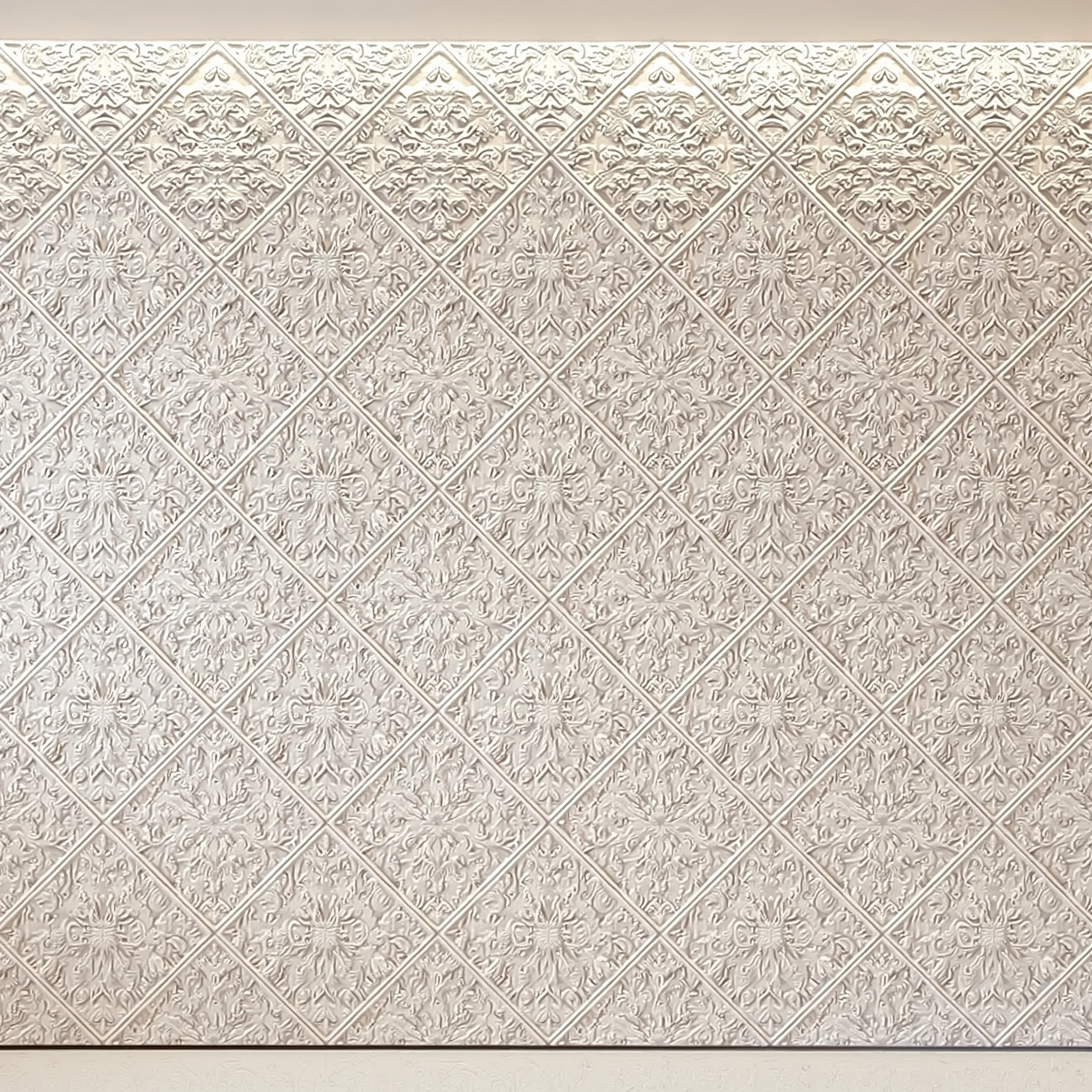 Gypsum ornament with oriental motifs, slightly worn plaster, diamond ornament, uniform lighting, light milky.