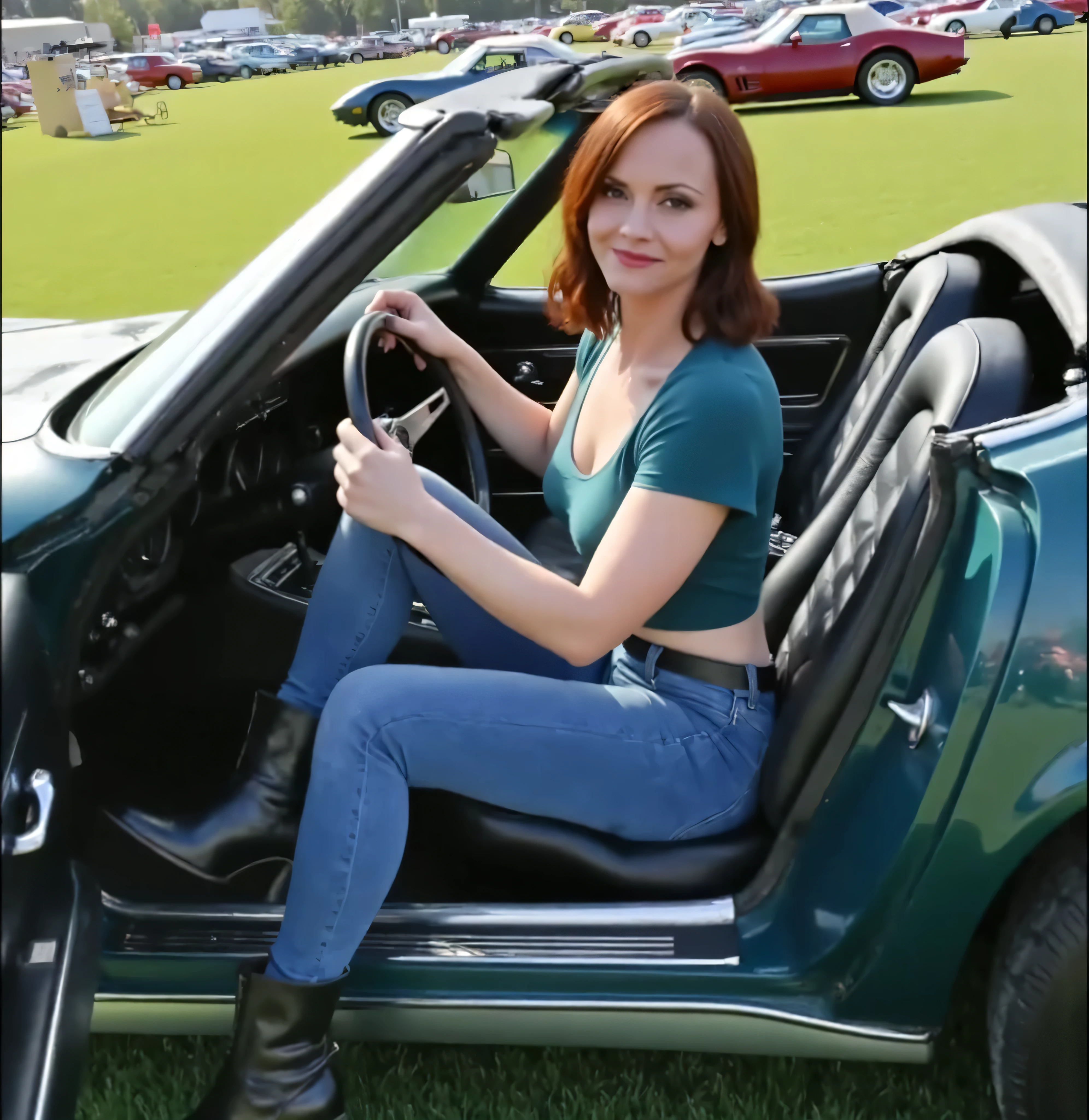 A 30 year old woman with dark red hair, long hair, dressed in blue jeans, a teal T-shirt, and combat style boots, (((she sits in a car, both hands on the steering wheel))), her legs stretched out, (((side view of a shiny 1973 dark blue-green corvette convertible,))),. The car sits in a beautifully grassy field filled with other classic cars.