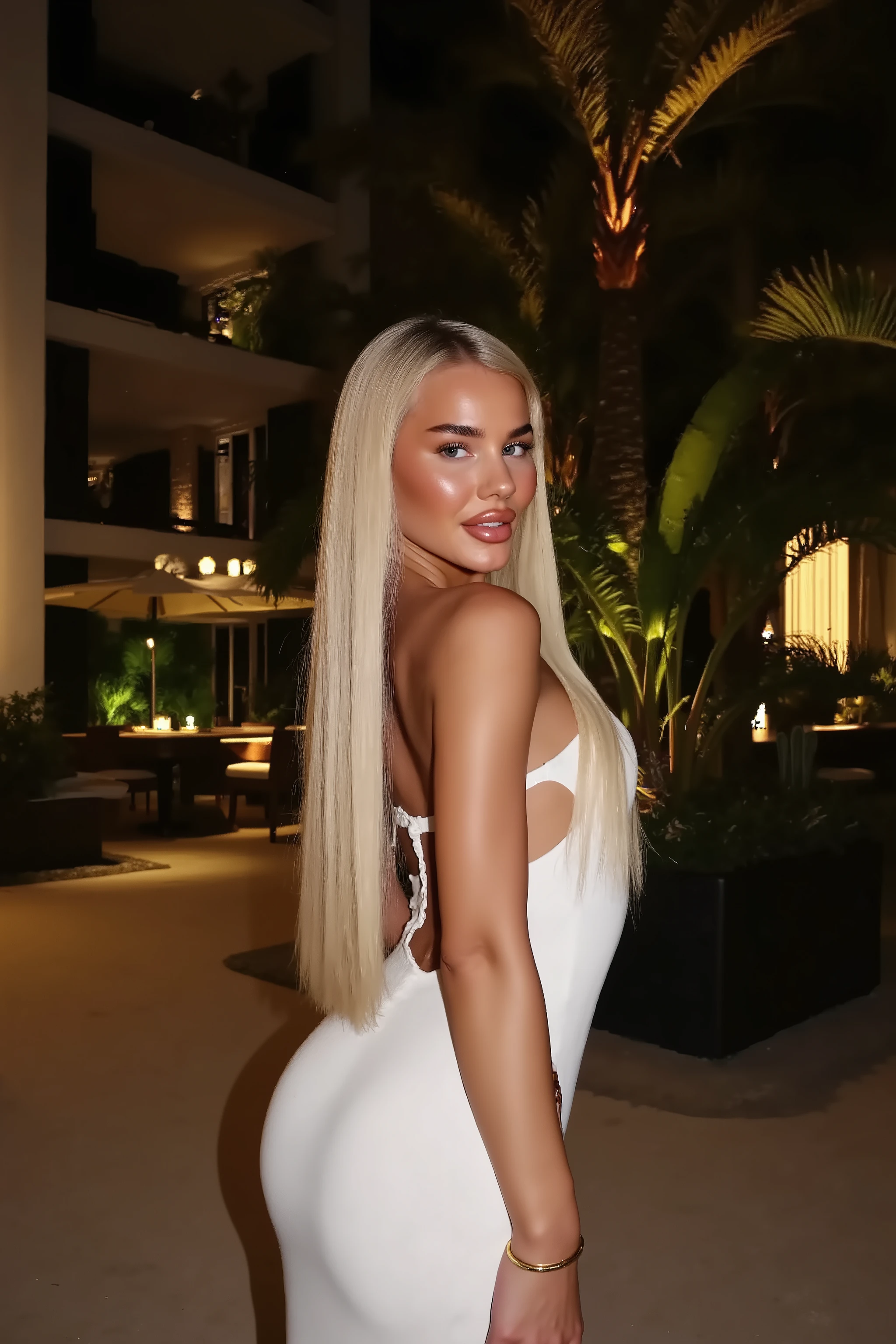 21 year old woman with very long white straight hair posing inside of a luxury modern villa, she is wearing white dress, its night time, photo is taken with strong camera flash she has perfect skinny , photo is very very detailed and sharp her hair is completely straight, the photo is very sharp and very high quality, the photo is hyper realistic and the colors are more contrasted, photo is taken with flash on the phone, the photo is hyper realistic, photo is like taken with iphone, it looks like influencer post on instagram, she has very big DD cup  her hands are out of picture screen or hidden, 
