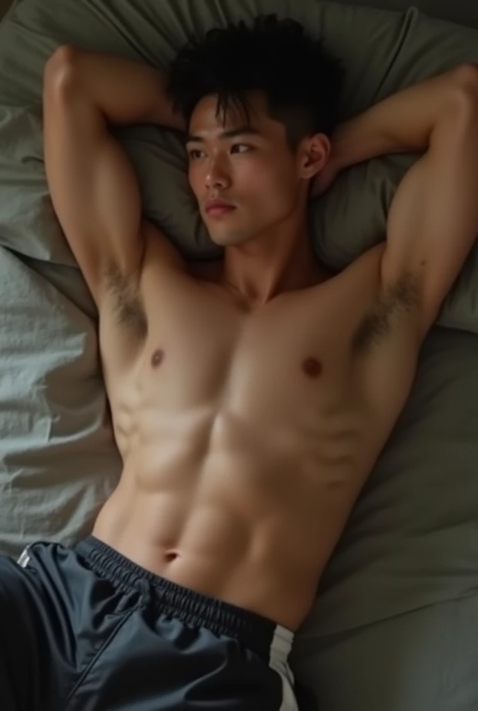 Handsome, muscular young Asian white skinned man laying on the bed, resting on his elbow, wearing only micro cheetah  