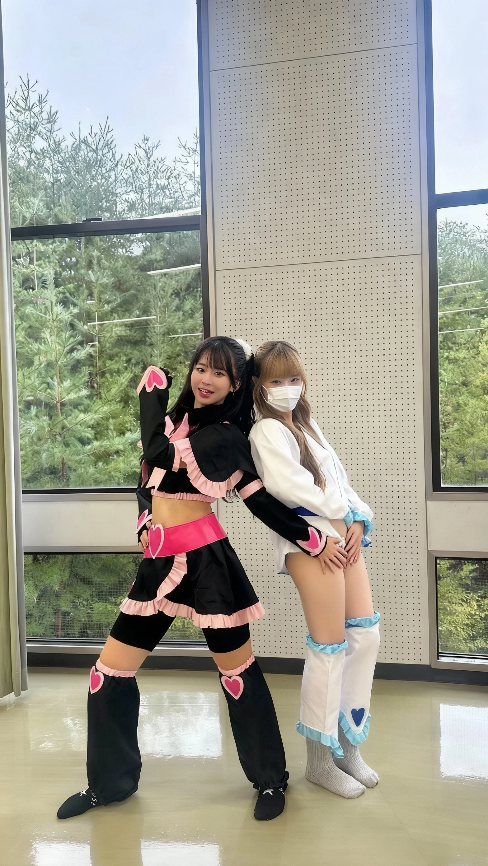 Floor-to-ceiling windows in the living room on the 180th floor of the Shanghai Tower door，Pouting and smiling，Two little girls in openwork translucent stockings holding toys，Pout，Pink double-tailed hair and cyan eyes，Anime little girl in servant costume