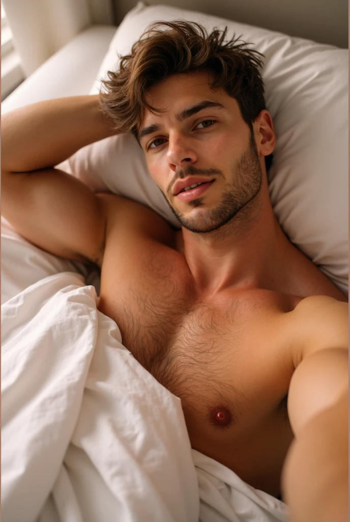Young man lying and covered in his bed thinking and with a half smile 