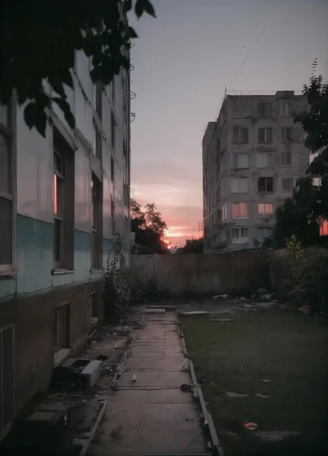 ground view, yard with large buildings, russianebenya, sunset, trees and bushes, movie still, 30mm lens, polaroid, analog photo, vhs, lomo, masterpiece, best quality, (film grain:1.1), ultra high res, RAW <lora:russianebenya_v2:0.8>