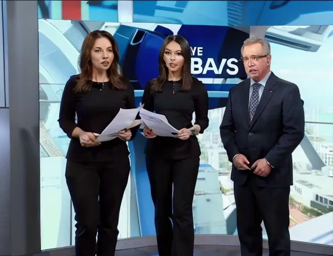 JS_News,leading news,in news studio,big screen in the background,1girl,standing,1boy,papers in hands,jackets,black pants,full body,a man and a girl presenting the news, <lora:JS_NewsV1:0.78>
