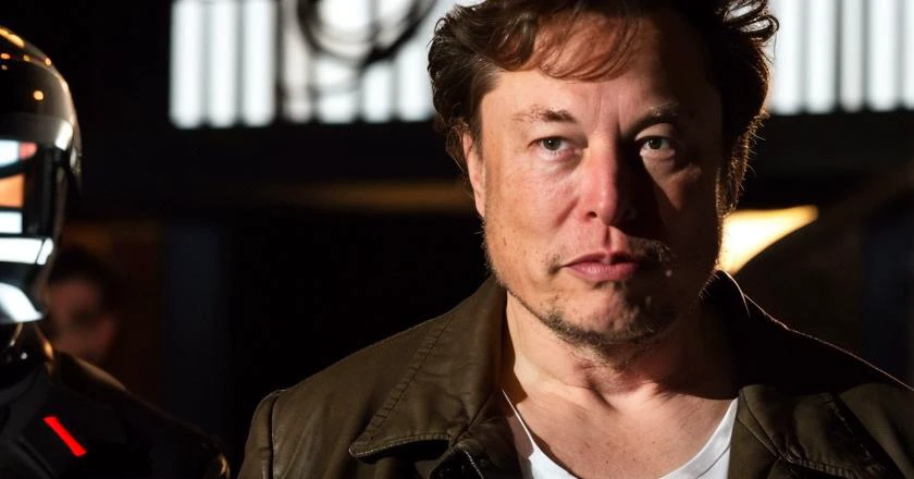 film footage of elonmusk person __scenario-romance__ with a __NounPerson__ . __film-genre__  film directed by __artist-director__  . Elonmusk person is __Happiness__ and __adj-horror__, shocked at the power of Artificial Intelligence. __musk-nouns__ __musk-verbs__ [ __gpt-villian-terms__|__gpt-dementia-nouns__|__gpt4-film-scenarios__]  . {__gpt-yacht__| __Locations-Suburban-Town__|__Country__|__Mall-Locations__|__Seattle-Locations__|__school-locations-high-school__|__college-campus-locations__|__Chicago-Tourist-Locations__|__NounLocation__}, intricate cinematography, high quality award winning  footage. __ArtLighting__, moviel in the style of /" { __80smovies__|__90smovies__ "/, heavy acid rain. Kodachrome.