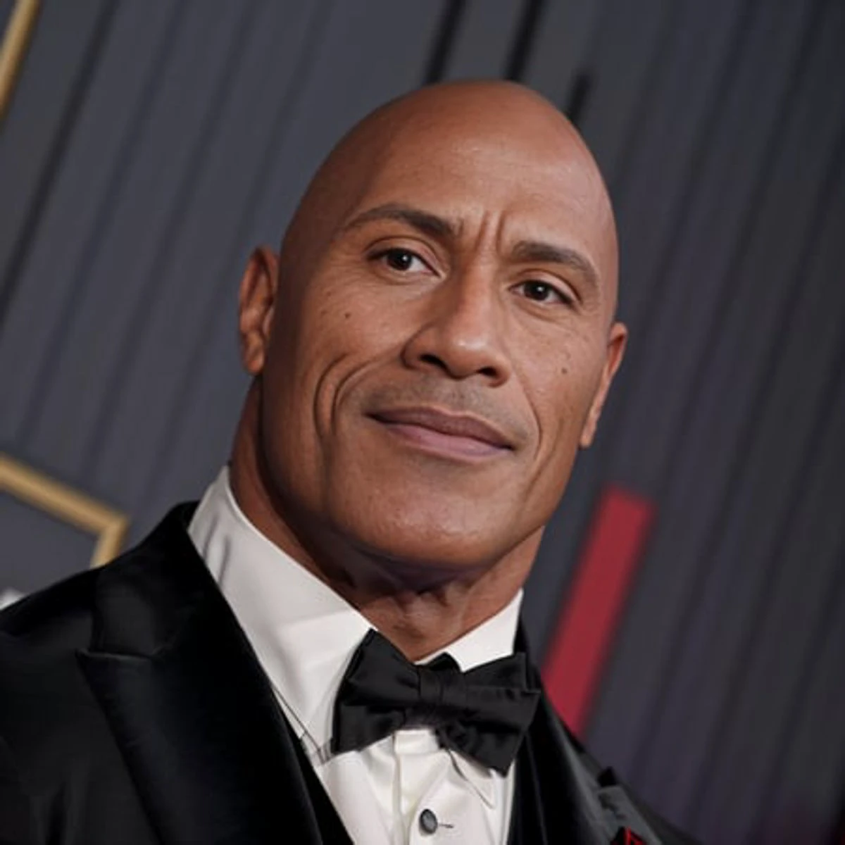 a RAW photo of th3rock, at a red carpet event, tuxedo, (muscled:1.5), 8k, uhd, realistic skin, clean skin, high quality, soft lighting <lora:dwayneTheRockJohnson_v1:1>