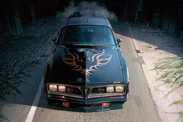 analog gloomy photo of a black car, <lora:tr4ns4m:1>, ((in new york city in 1977(at night))), (abandoned buildings), (graffiti), (horror ), ((nighttime)), dangerous, High Detail, Sharp focus, (photorealism), realistic, best quality, 8k, award winning, dramatic lighting, epic, cinematic, masterpiece, rim light, (ambient fog:1.5), smoke:0.2, dutch angle, depth of field, wide angle lens,