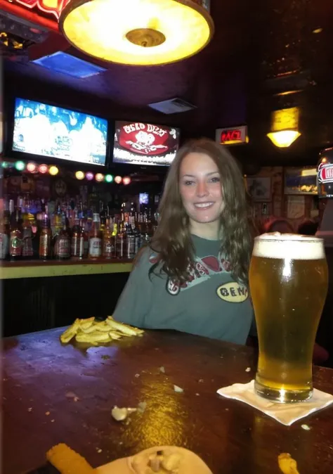 Freya Ridings with short hair holding a beer completely naked and smiling