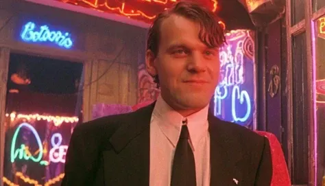portrait photo of a german man outside a night club, morning, 1990, tuxedo, suit, <lora:badquality_v02:1> bad quality