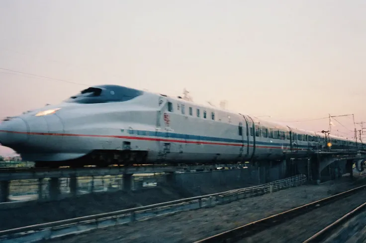 <lora:SDXL_FILM_PHOTOGRAPHY_STYLE_BetaV0.4:1> <lora:add-detail-xl:2.0> film photography style, heavy grain, a bullet train rushing, minimalistic, dusk