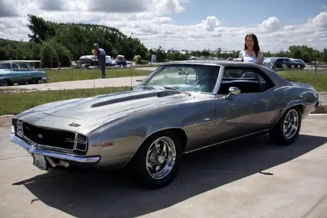 <lora:DianeWebber:0.85>, realstic photo of dianewebber, a woman standing next to a <lora:60s_Camaro:0.8> silver camaro, simple background, (masterpiece:1.0), (best quality:1.0), beautiful, (intricate details), unity 8k wallpaper, ultra detailed