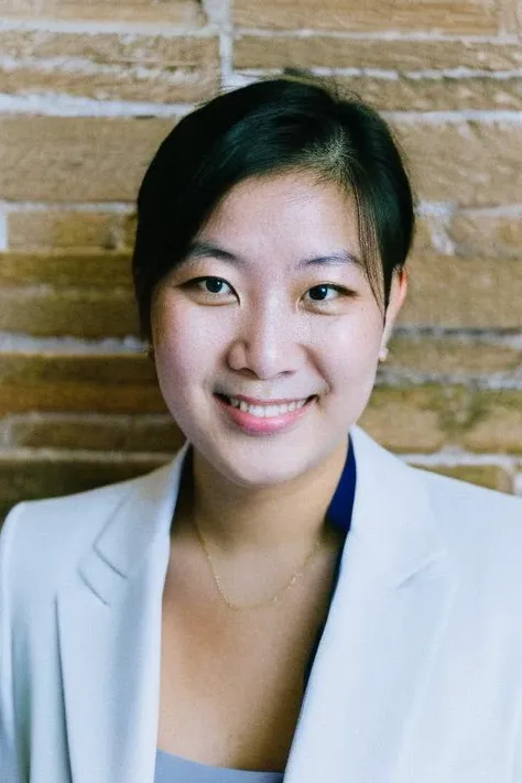 official portrait,official government photo,portrait photo of a 23 y.o Mongolian woman,round face,early twenties age,wearing business suit,short hair,upper body,in studio,simple background, <lora:lyco_humans_v10:1>