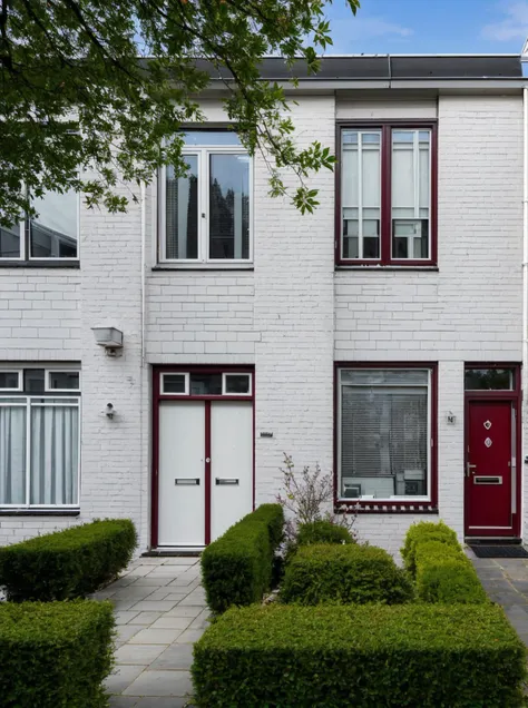 <lora:Grienden_Style_Revisited:0.8>, griendenstyle, row of houses in a street, white bricks, red doors, slanted roofs