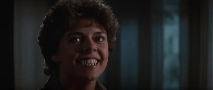 cinematic film still of <lora:Fright Night 1985 style v2:1>
In the 1980's Amy Peterson Amanda Bearse a woman with a very big smile on her face,solo,looking at viewer,brown hair,1boy,brown eyes,male focus,teeth,clenched teeth,portrait,realistic , horror themed, dark themed, low key light, dramatic light, dramatic shadow light, contrast, cinematic color, cinematic look, filmic, realistic, realism, perfection, perfect, Kodak, Kodak film, movie still, Fright Night 1985 style, Fright Night Film style, shallow depth of field, vignette, highly detailed, high budget, bokeh, cinemascope, moody, epic, gorgeous, film grain, grainy