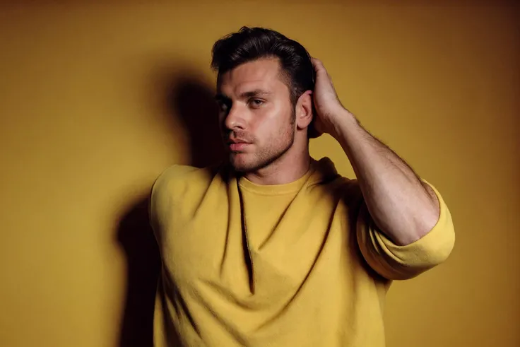 stubble, 80's heartthrob, 1boy, bara, muscular, hunky male, homoerotic, wearing a Retro-style sweatshirt, handsome man, sunkissed, professional lighting, artistic shot, cinematic, yellow background