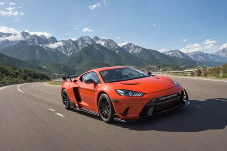 a photo taken of the front of a super-car drifting on a road near mountains at high speeds with smokes coming off the tires, front angle, front point of view, trees in the mountains of the background, ((sharp focus))