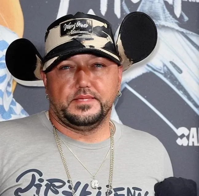 (crying) (tears) jasonaldean person (wearing a dress:1.2) (horrified facial expression) (wet eyes) (bawling), (at Disney world in Florida:1.2)