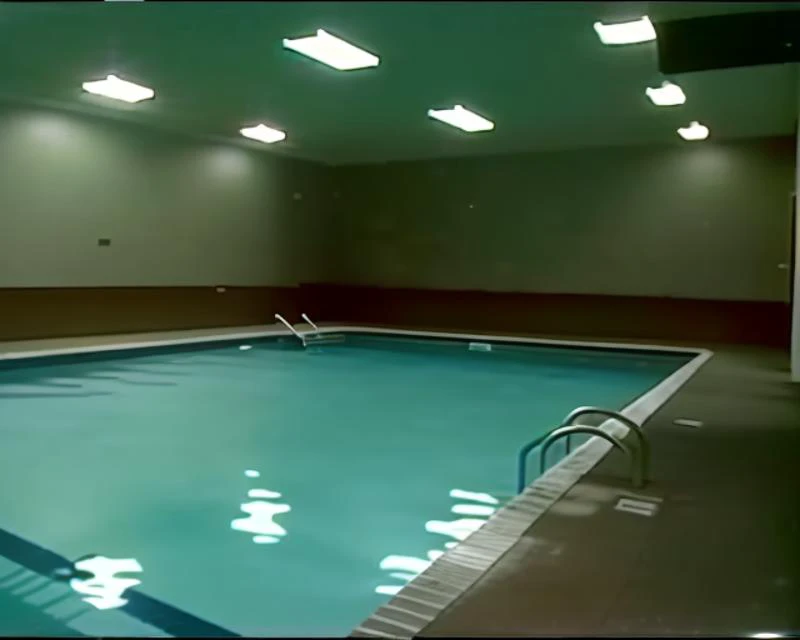 VHS footage, indoor pool, dark, no people, <lora:epiNoiseoffset_v2:1> <lora:badVHS_v101:1>