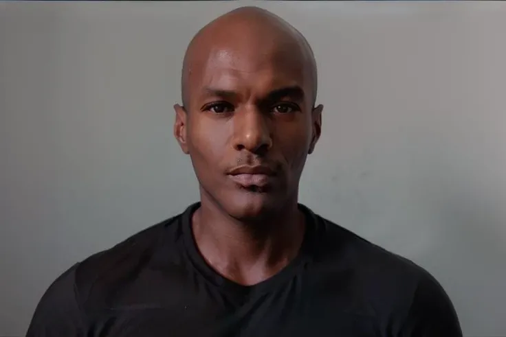 <lora:rhyheimsv3:1> rhyheims, black man, bald, dark skin, brown eyes, professional studio quality modeling headshot, 4K, simple dark background, dramatic lighting, neutral expression, realistic skin, fine detail, shirt, ultra realistic photograph, professional photograph, by Gucci photographer.