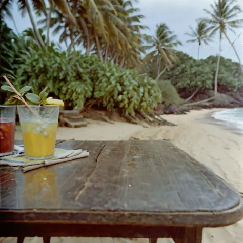 c41_hasselblad_portra400, Beach (Sri Lanka) in the foreground a wooden table with cocktails and tropical fruits and in the background a few people