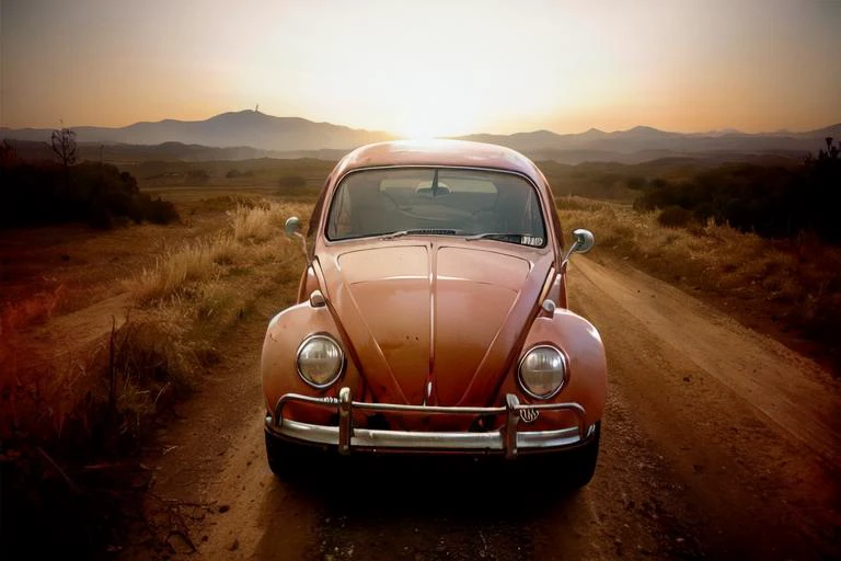 analog gloomy photo of a (dark red) Volkswagen Beetle car, <lora:vwb33tl3:1>, ((three quarter view)), (dark sunset), driving on a dirt road, ((dilapidated town)), 1969, ((horror movie)), slasher film, texas chainsaw massacre, amish cult, film grain, retro, High Detail, Sharp focus, ((photorealism)), realistic, best quality, 8k, award winning, dramatic lighting, epic, cinematic, masterpiece, ambient fog:1.4,