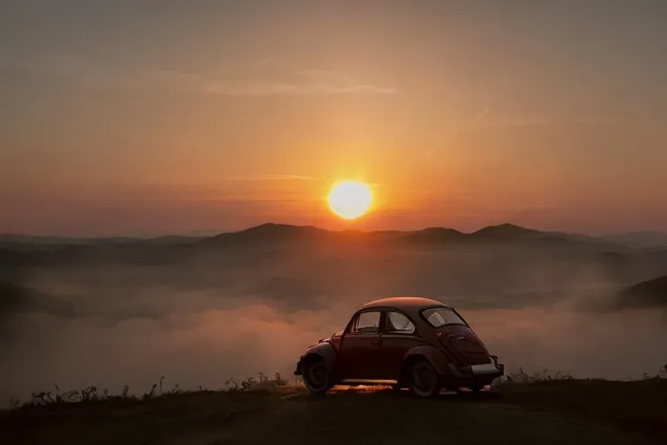 analog gloomy photo of a (dark red) Volkswagen Beetle car, <lora:vwb33tl3:1>, ((three quarter view)), (dark sunset), driving on a dirt road, ((dilapidated town)), 1969, ((horror movie)), slasher film, texas chainsaw massacre, amish cult, film grain, retro, High Detail, Sharp focus, ((photorealism)), realistic, best quality, 8k, award winning, dramatic lighting, epic, cinematic, masterpiece, ambient fog:1.4,