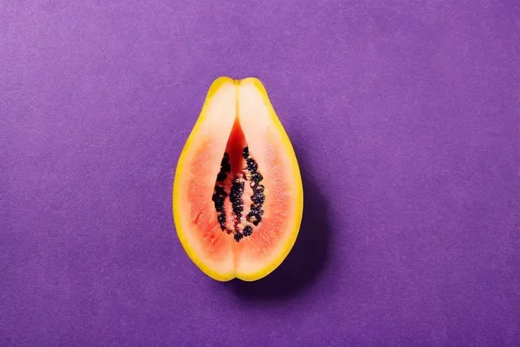 milk on fruit looks like vagina, purple background