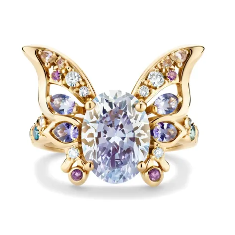 An 18k gold ring with slender and dynamic arms for women, in a Victorian style with hand-painted effect. The ring is shaped with butterfly elements, the main stone is set with purple colored gemstones, the butterfly wings are partially enameled with hollow windows,and the colors are a dreamy blue and purple gradient