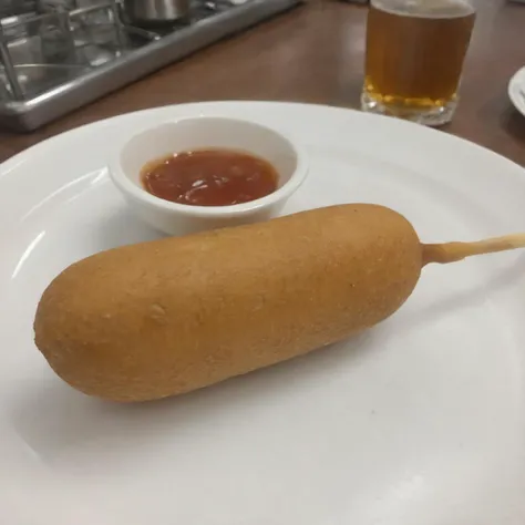 A photorealistic image of a delicious 9hotdog placed on a plate in a restaurant setting. The 9hotdog should be golden brown, with a crispy exterior and a juicy interior visible at one end where it's bitten off. The plate can be white or a light color to contrast with the golden hue of the 9hotdog. There might be a small dish of mustard or ketchup on the side for dipping. The table should have a clean tablecloth, and the lighting should be warm, highlighting the appetizing look of the 9hotdog. The background can have subtle hints of a restaurant ambiance, like a glass of water or some cutlery, <lora:cornhotdog:0.65>, (bottle of soda),<lora:applesoda:0.75>