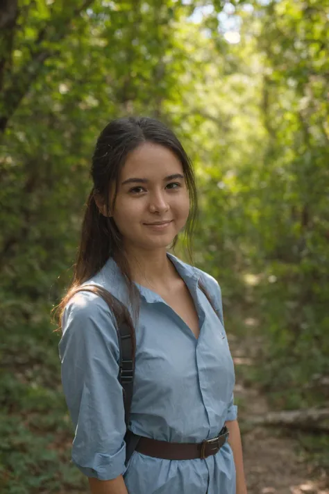 a perfect well-lit (closeup:1.15) (medium shot portrait:0.6) photograph of a beautiful woman standing on the hiking trail, wearing an intriguing outfit, looking at me, coy slight smile