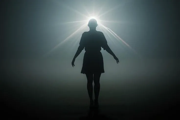 Hyperrealistic photograph of a silhouetted female figure, spectrum. Vertical bands of light transition through vivid blues, warm yellows, to intense blues. Figure stands centrally, arms slightly outstretched, draped in flowing, gossamer-like fabric. Hair and dress edges blend seamlessly into the light, creating an ethereal glow. Lower half of the image filled with billowing mist, reflecting the colored light. Ground appears wet, mirroring the spectrum above. Sharp contrast between the dark silhouette and the brilliant background. Cinematic quality lighting, emphasis on color saturation and light diffusion. Ultra-high resolution capture of light interacting with fabric and mist particles.
