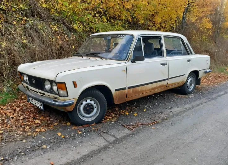 realistic photo of rusty white polish 80s sedan car, parked at the side of the road, broken down, one flat tire, abandoned, dent in the fender, rust,
<lora:POLISH_80S_SEDAN_CAR:0.8>