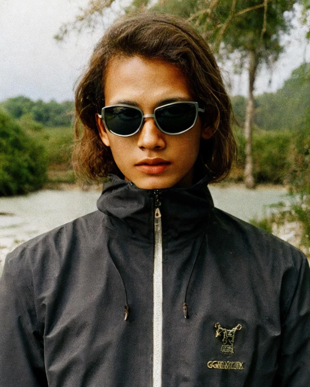 ,black jacket,sunglasses, detailed face, masterpiece,gorpcore,80mm f/11 on kodak ektachrome e100, soft focus, film grain, muted colors,swamp,jungle,,psychedelic, <lora:gorpcoreLORA:1>