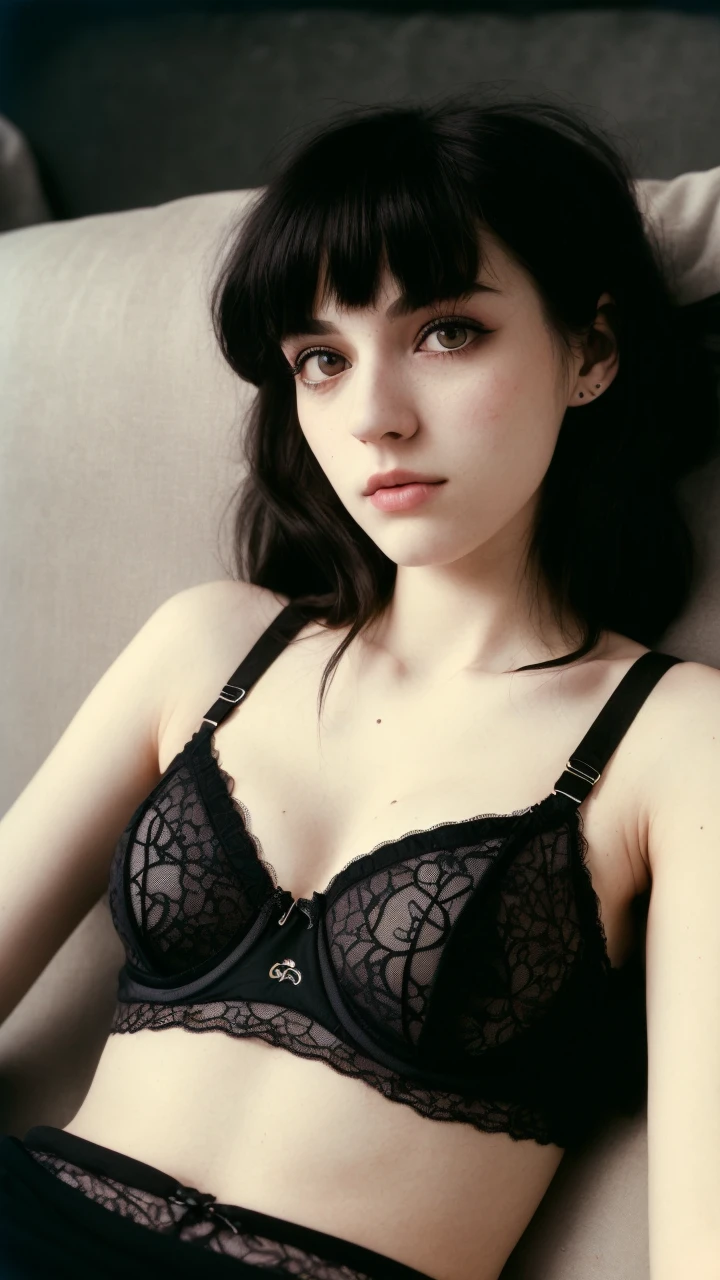 vintage analog photo of a 20 y.o woman, average looking person, dark hair, alternative rock style, e-girl makeup, grunge aesthetic, emo girl, punk rock, ((wearing a black bra)), detailed lace, ((wearing sweatpants)), detailed fabric, sleeping girl, tired eyes, subtle smile, (pale skin), (detailed face), (detailed iris), thin body, large breasts, ((full body)), ((lying on the couch)), resting, (high detailed skin:1.2), flash photography, low resolution, ((film grain)), disposable kodak film