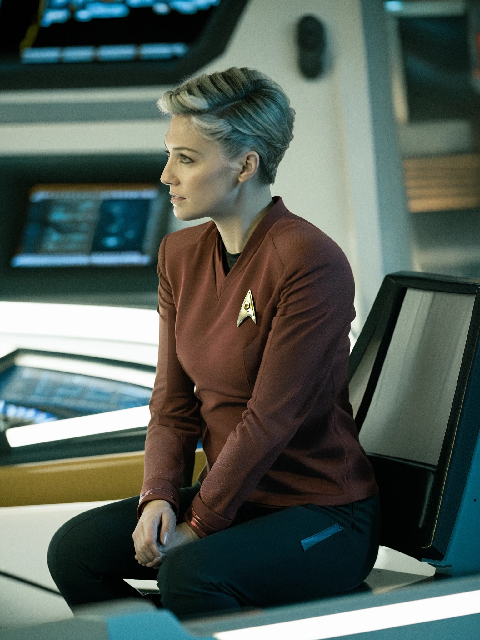 blond woman in red stsnwunf uniform,sitting on a chair on starship bridge,short hair<lora:DSSNWXL:0.8>