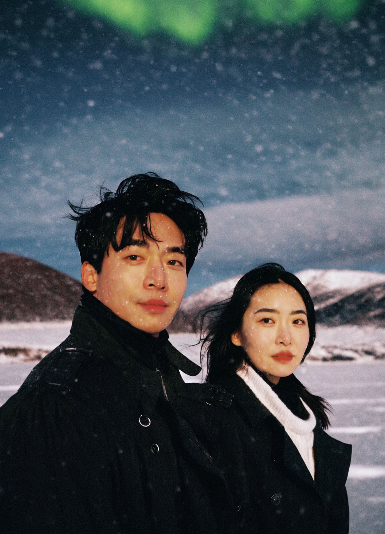 a man and woman standing in the snow,asian,Film photography,arctic,(a shallow smile:1.1),facial close-up,black trench coat,movie still promotion,live-action adaptation,teen magazine cover,album photo,newspaper picture,heavy snowfall,the aurora borealis is reflected in the water,pexels contest winner,breathtaking mountains,desktop screenshot,looking at the camera,