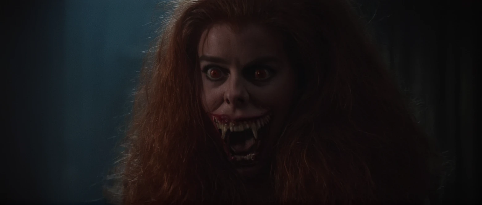 cinematic film still of  <lora:Amy Peterson:0.9>
Closeup, staring at camera, angry, open mouth, Amy Peterson, In the 1980's Vampire2 Monster Creature Amy2,big scary eyes,big monster teeth,big teeth,scary teeth,dull hair,big mouth,vampire makeup,freak,a woman with red hair and a creepy face,1girl,solo,long hair,looking at viewer,open mouth,brown hair,teeth,orange eyes,saliva,fangs,sharp teeth,portrait,realistic, angry, nose,dark,horror (theme) , Horror themed, dark themed, Fright Night 1985 style, shallow depth of field, vignette, highly detailed, high budget, bokeh, cinemascope, moody, epic, gorgeous, film grain, grainy
