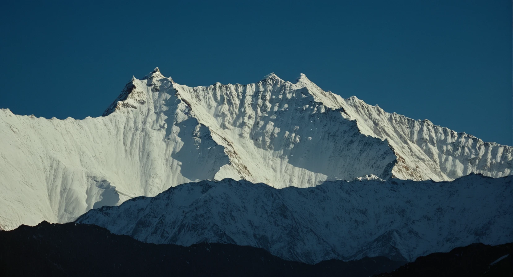 cinematic film still of <lora:Ron Fricke style:1>
a mountain range with a snow covered mountain in the background,outdoors,sky,day,blue sky,no humans,scenery,snow,mountain,landscape,mountainous horizon , realistic, realism, movie still, film grain, kodak film, film contrast, film color, cinematography, documentary, photography, 70 mm film, 65 mm film, Todd-AO, Todd-AO 35, 8K resolution, Ron Fricke film director style, Ron Fricke film directing style, Ron Fricke style, shallow depth of field, vignette, highly detailed, high budget, bokeh, cinemascope, moody, epic, gorgeous, film grain, grainy