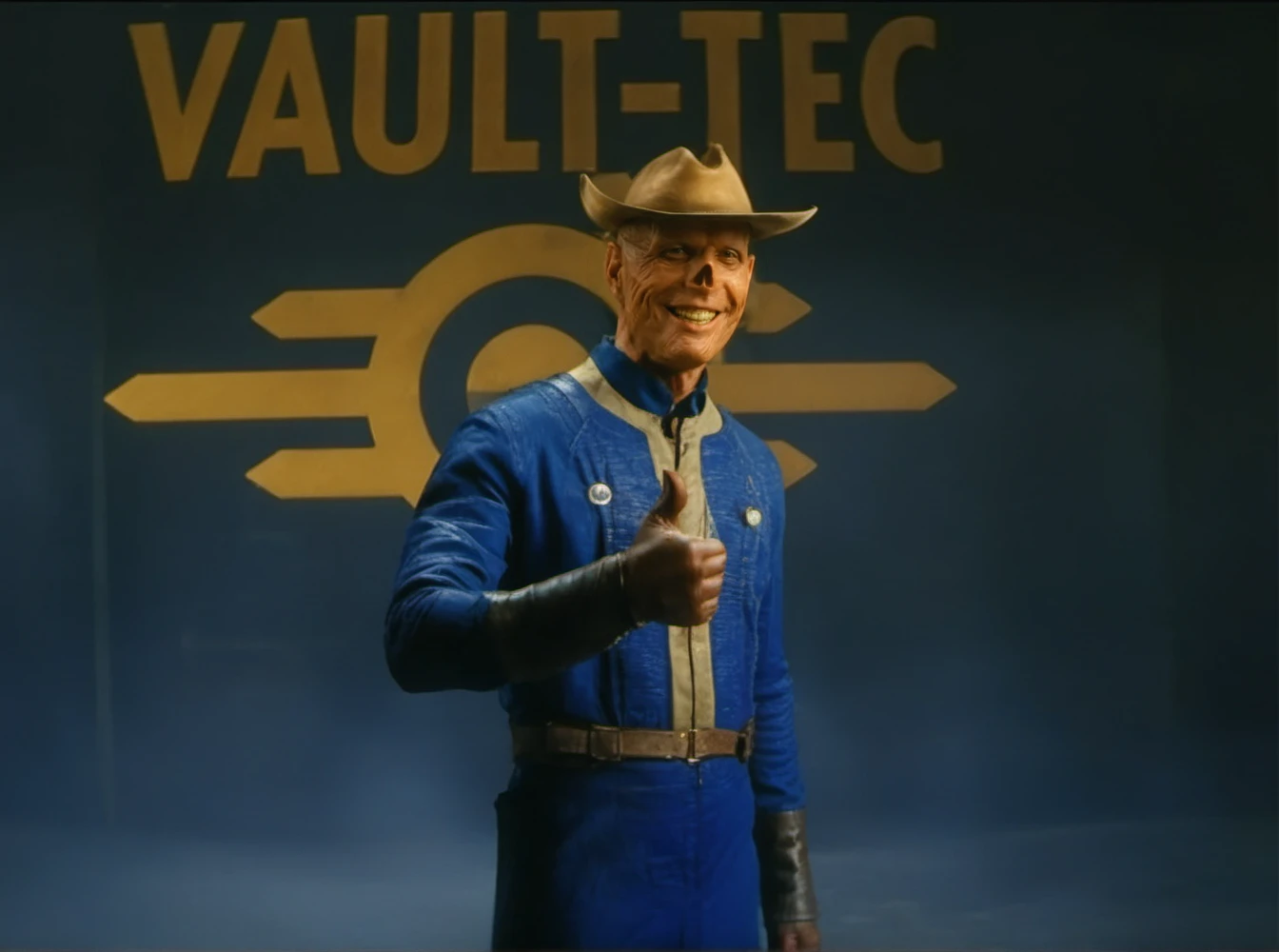 cinematic photo a bald ghoul cowboy with a hat, smiles, thumbs up, text ''VAULT-TEC'' <lora:TheGhoul1024:0.85>  . 35mm photograph, film, bokeh, professional, 4k, highly detailed