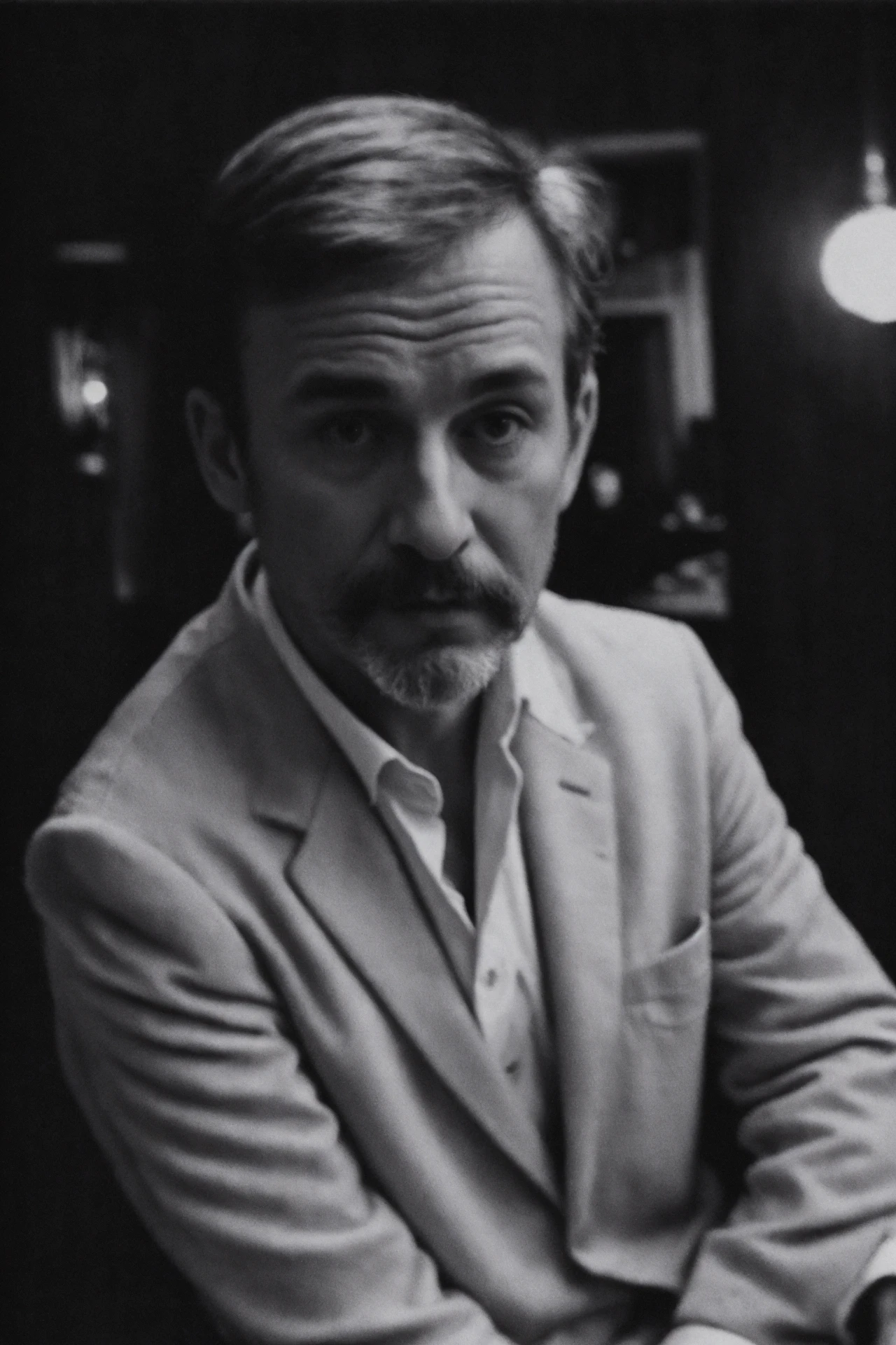 documentary photo of mid-age casual man, wearing tuxedo, cosy atmosphere looking at the viewer, grainy, dimly lit, (high detailed skin:1.1), technicolor, soft tones,dreamy haze,perfect face,by Lee Friedlander