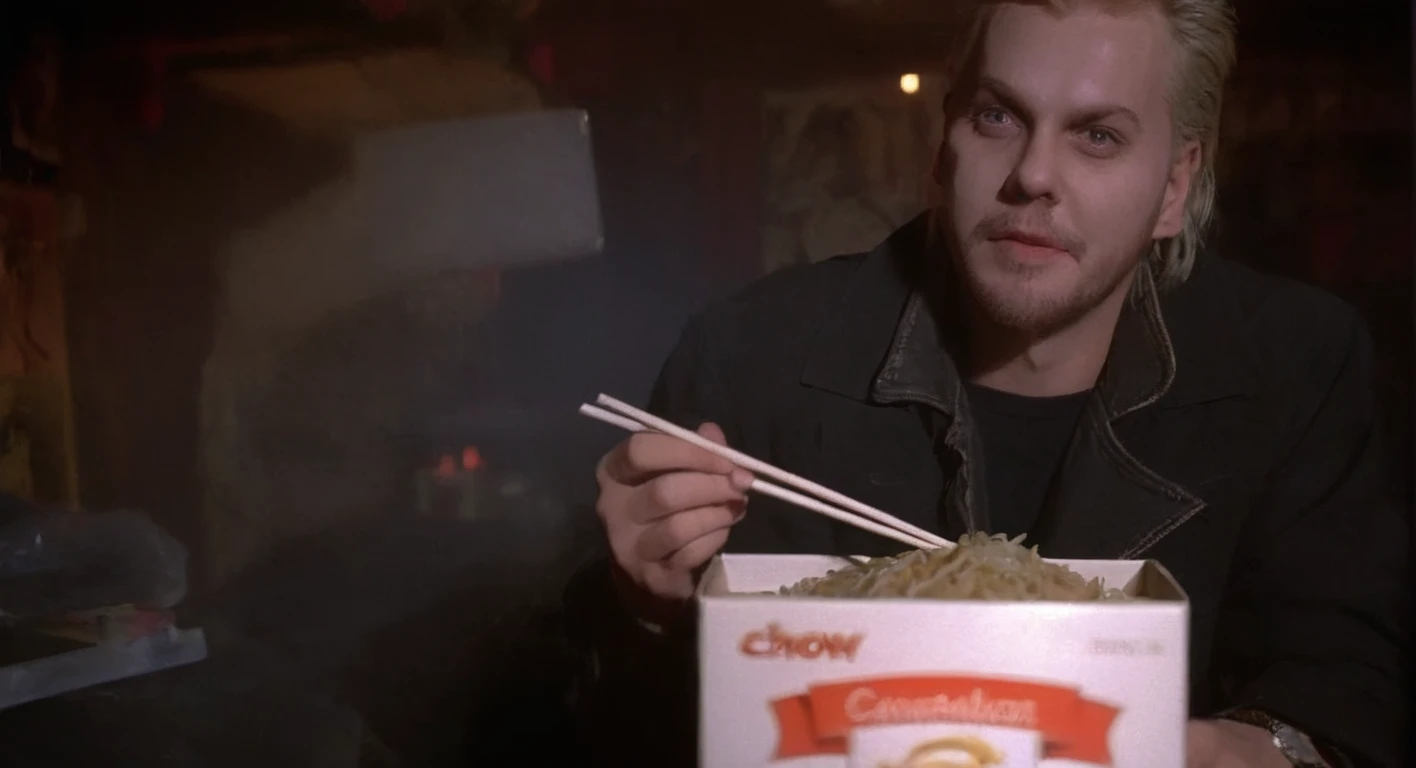 cinematic film still of   <lora:d4v1d:1> d4v1d man at (cavebackground), overhead spotlight, white light, holding small white box of chow mein and chopstick, medium shot, sharp focus, Kodak Eastman 100T 5247 Cinematic 1982 Film Stock Footage, shallow depth of field, vignette, highly detailed, high budget, bokeh, cinemascope, moody, epic