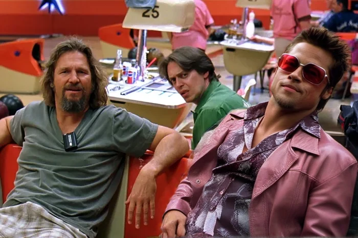 cinematic photo Tyler Durden, facial hair, red jacket, shirt, sunglasses<lora:TylerDurden1024:0.8> sitting next to the dude and donnie . 35mm photograph, film, bokeh, professional, 4k, highly detailed