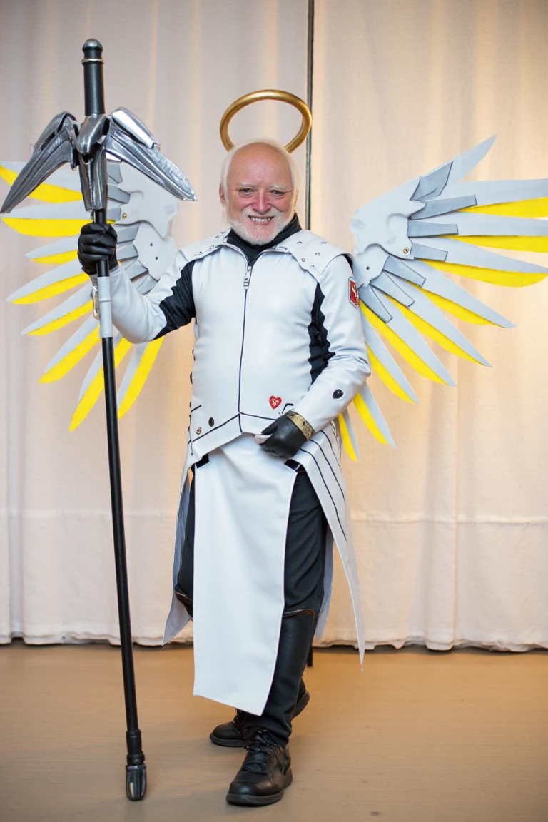 (harold, an old man) is cosplaying as mercy in a white body armor with mechanical wings with glowing blades and a staff, golden halo